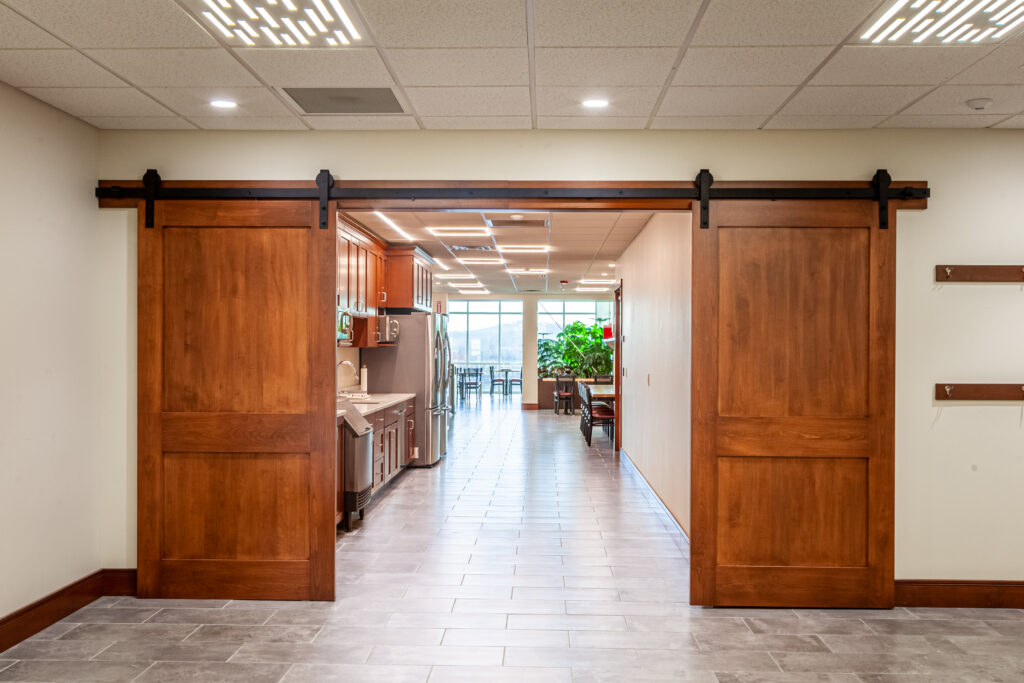 Double Barn door sliding doors leading into a workplace cafeteria